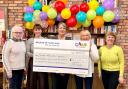 MILESTONE: Former Sterling Furniture managing director Suzanne Howarth, CHAS retail project manager Johann Lovell, Mill Café manager Eileen MacKay, CHAS volunteer Helen Muirhead and CHAS community fundraiser Lyndsay Stobie celebrating the achievement
