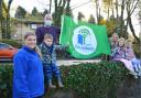 Kids and staff at Flying Start nursery raise their first ever Green Flag. Photo by Jan van der Merwe