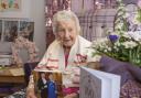CENTENARIAN: Joanne Adams' meets the provost and holds up her card from the King. Pictures: Scott Barron Photography.