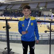WINNER: Alfie Laing picks up his bronze medal in the U13 boys pentathlon.