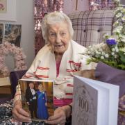 CENTENARIAN: Joanne Adams' meets the provost and holds up her card from the King. Pictures: Scott Barron Photography.