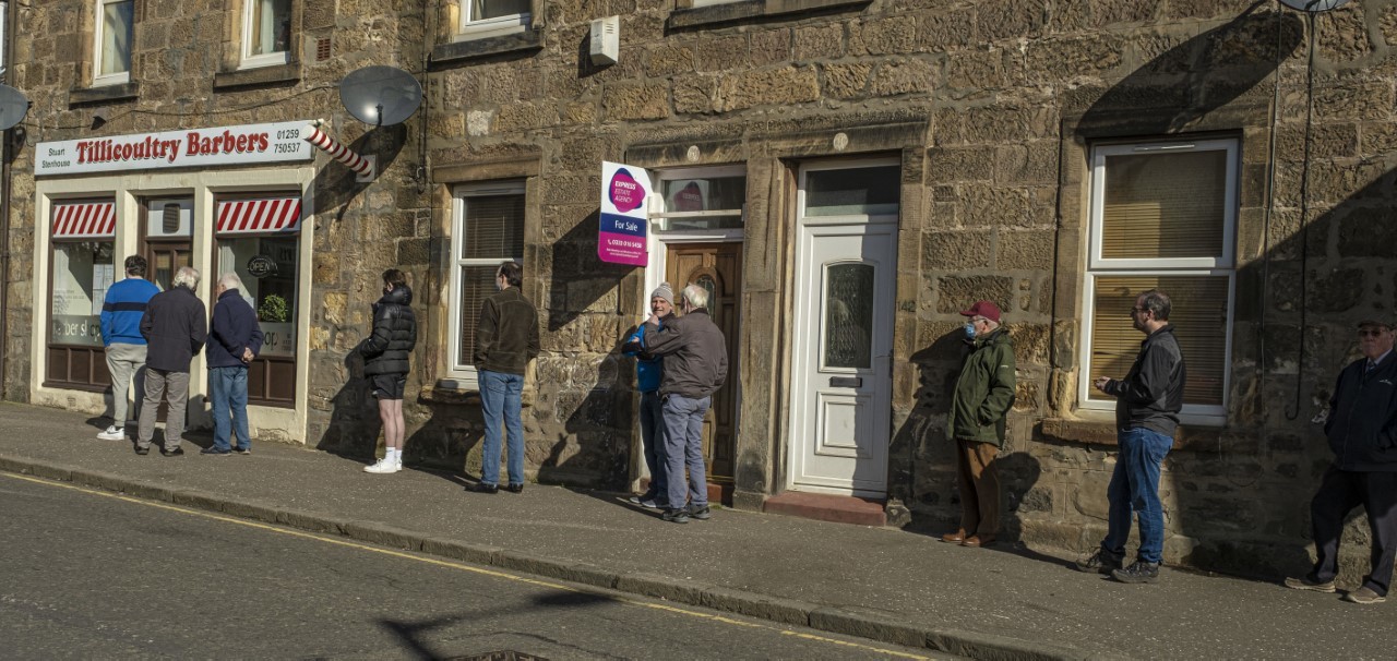 A queue of bookings waits outside Tillicoultry Barbers on its reopening day after the latest lockdown