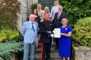 June Anderson received her BEM after a delay due to the pandemic - she is pictured with Clacks Lord Lieutenant Johnny Stewart and her own family during the ceremony at Arndean