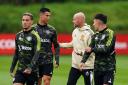 Erik ten Hag, centre right, speaks to Cristiano Ronaldo, centre left, in training