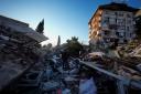 A man walks through the rubble of destroyed buildings in Antakya