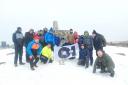 TEAM SPIRIT: The group from O-I Glassworks successfully climbed to the summit of Ben Nevis, with a copy of the Alloa Advertiser joining the team at the top