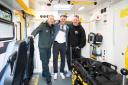 Callum Beattie, centre, views the interior of an ambulance with his manager Dave Rogers, right, and Bryan Finlay, community resilience team leader, left, during a visit to the Scottish Ambulance Service's East Ambulance Control Centre