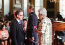Mr Stewart receiving his MBE from the queen
