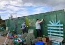 THISTLESHELPS: Volunteers from the shopping centre paint the Braehead community garden clubhouse.