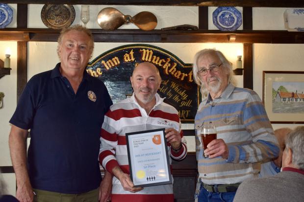 Forth Valley CAMRA volunteers Tony Lamb and Brian Cheeseman presented the award to the Gibson family at The Inn at Muckhart