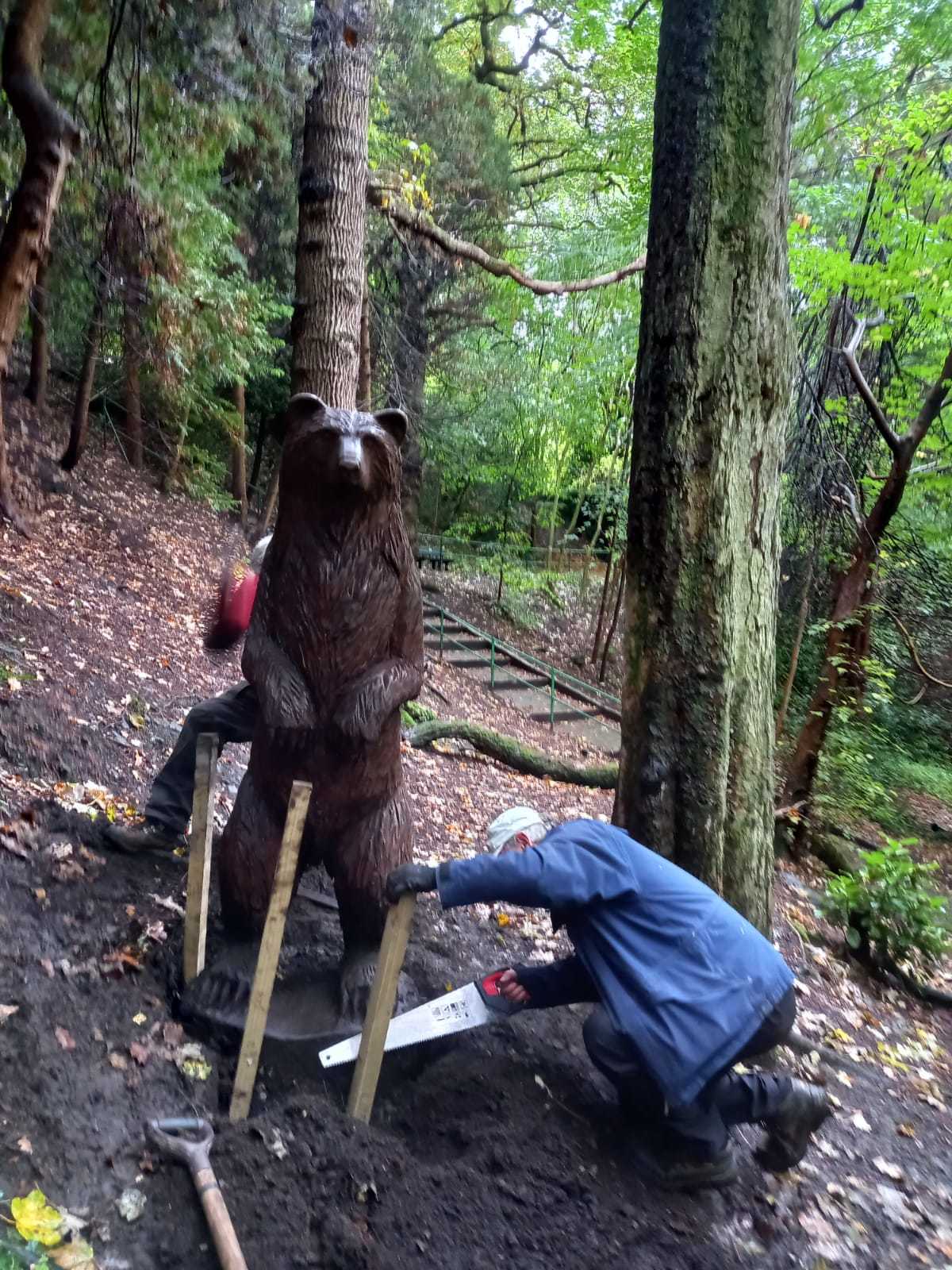 The wooden bear carving, weighing in at around half a tonne, being repaired