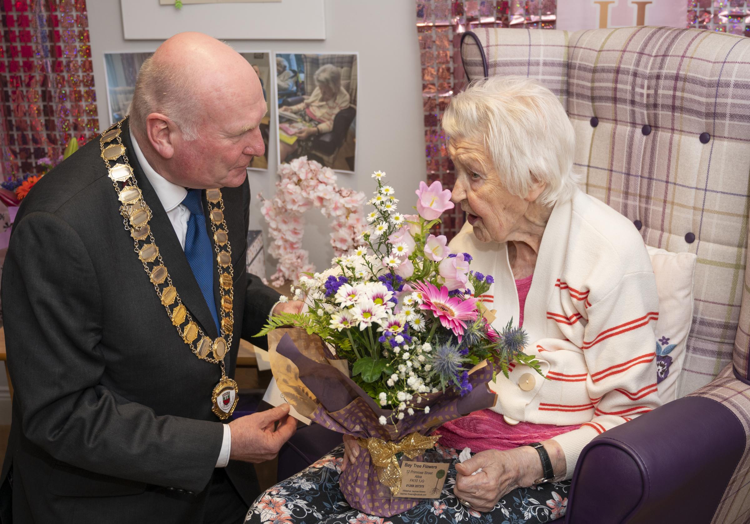 CENTENARIAN: Joanne Adams meets the provost and holds up her card from the King. Pictures: Scott Barron Photography.