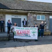 SAVED: Trustees of TCDT gathered outside Tullibody Civic Centre to celebrate the historic moment as they took the building into community ownership - Picture by John Howie