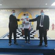 Son Russell and father John Scott last week handed over the cheque for £800 to Linda McLeod BEM