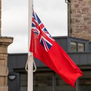 RESPECT: A crowd gathered to watch the Red Ensign flag be raised in honour of the Merchant Navy.