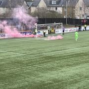 DAMAGE: The flares before the game caused damage to the pitch at the Indodrill.