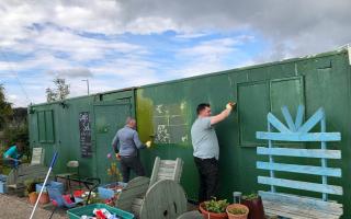 THISTLESHELPS: Volunteers from the shopping centre paint the Braehead community garden clubhouse.