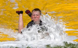 YOUNG FIREFIGHTERS: The slip 'n' slide was a particular highlight for the kids. Pictures by John Howie.